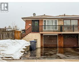 A house with a snow bank in front of it.