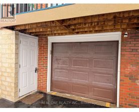 A brown garage door is on the right and a white door is on the left.