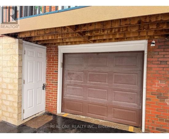 A brown garage door is on the right and a white door is on the left.
