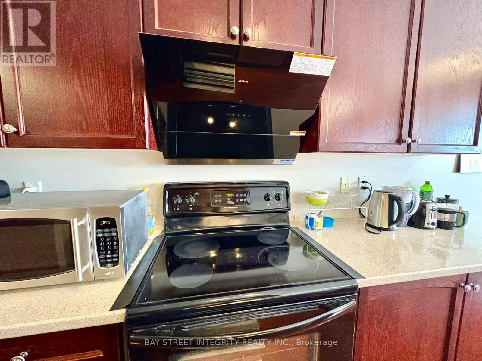 A kitchen with a stove top oven and microwave.