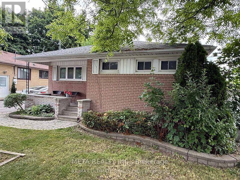 A house with a red brick exterior and a well-maintained garden.