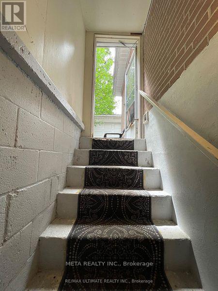 A set of stairs with a carpeted runner between the steps.