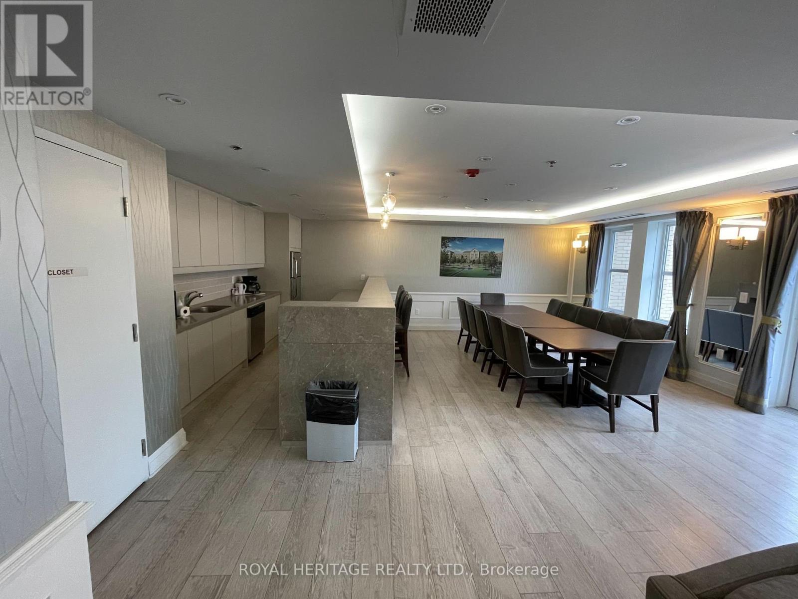 A spacious room with a dining table and chairs.