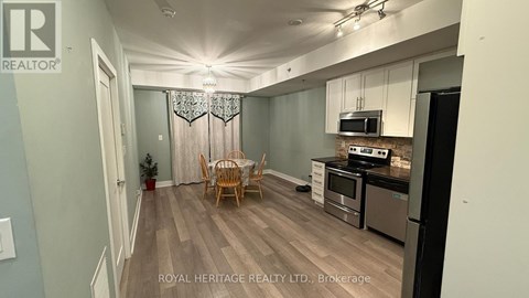 A kitchen with a dining table and chairs in the middle of the room.