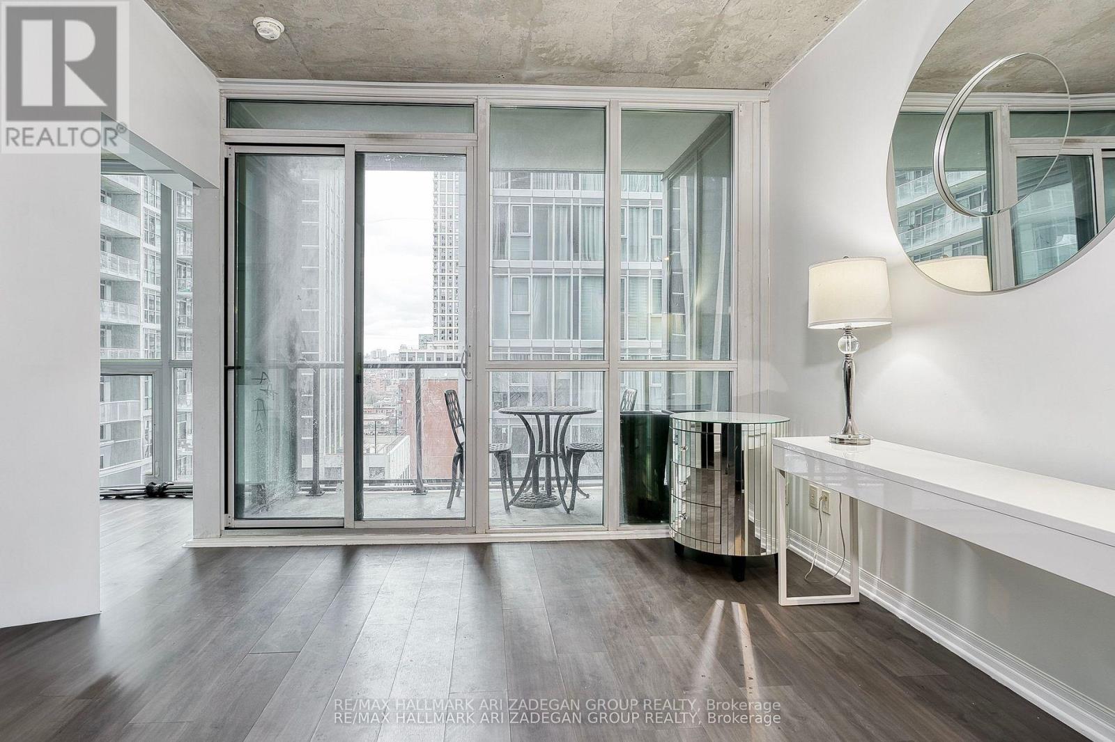 A modern living room with a large window and a view of the city.