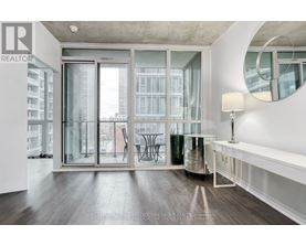 A modern living room with a large window and a view of the city.