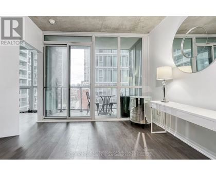 A modern living room with a large window and a view of the city.