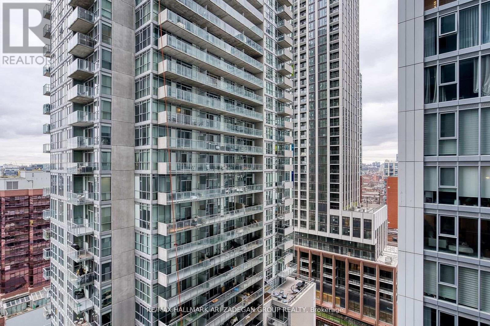 A tall building with many windows and balconies is shown in the image.