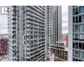 A tall building with many windows and balconies is shown in the image.