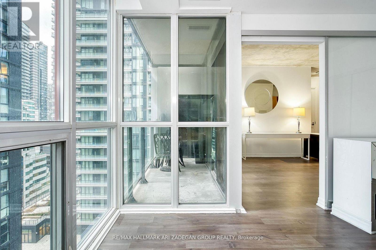 A modern interior space with a view of a cityscape through large windows.