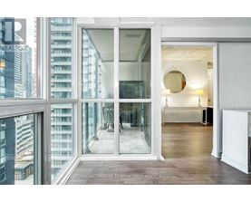 A modern interior space with a view of a cityscape through large windows.