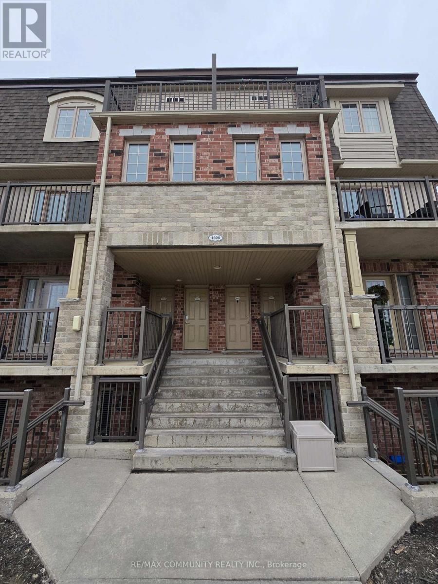 A multi-story apartment building with a balcony on the second floor.