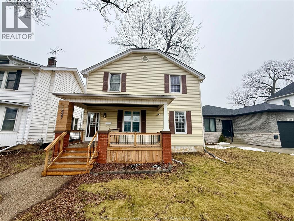 A house with a brown front porch and a white roof.