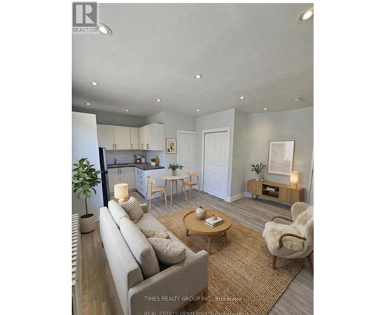 A well-lit living room with a grey sofa and wooden coffee table.
