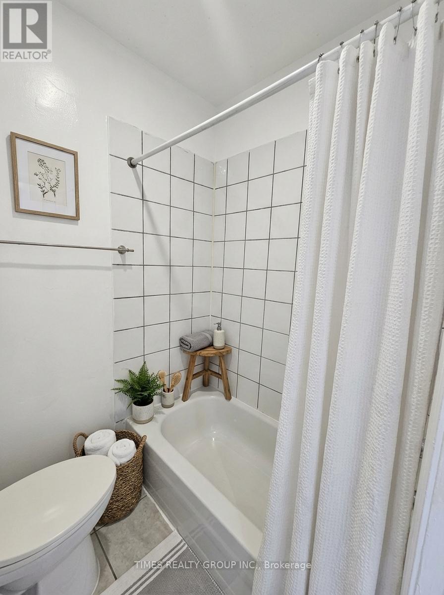 A white bathroom with a tub, toilet, and sink.
