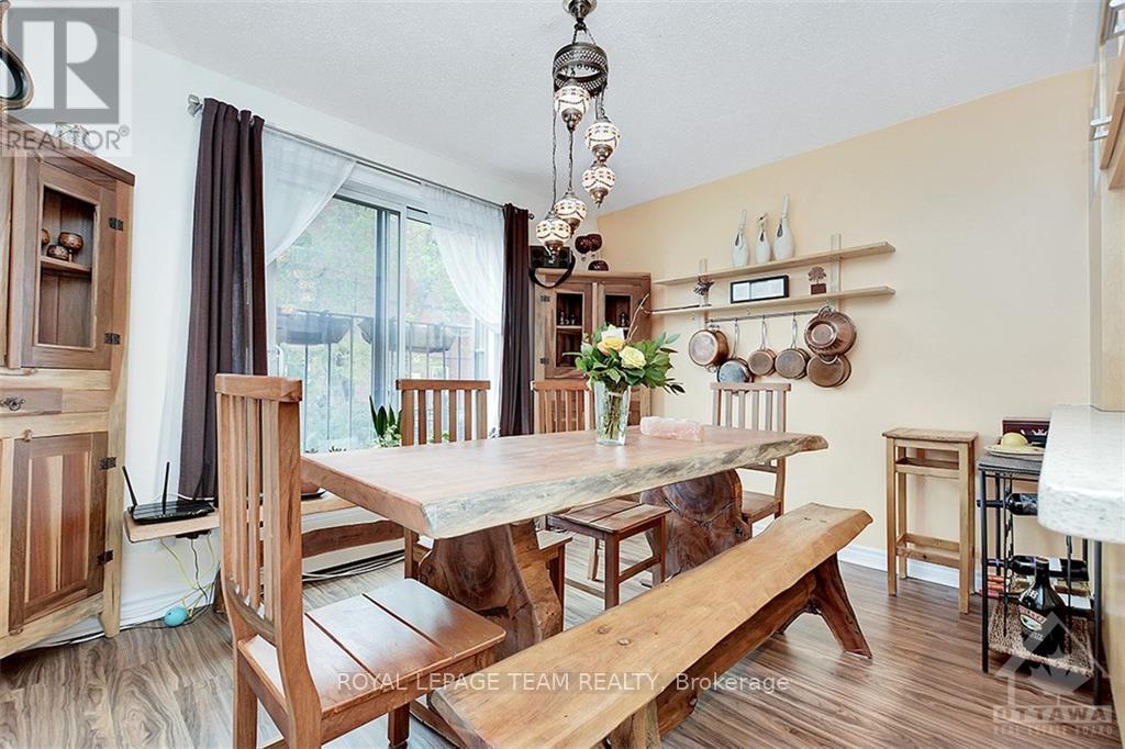 A dining room with a wooden table and chairs.