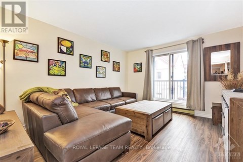 A living room with a brown leather couch and a coffee table.