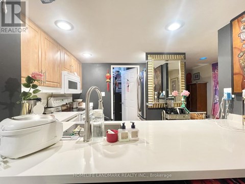A white kitchen with a sink and a toaster.