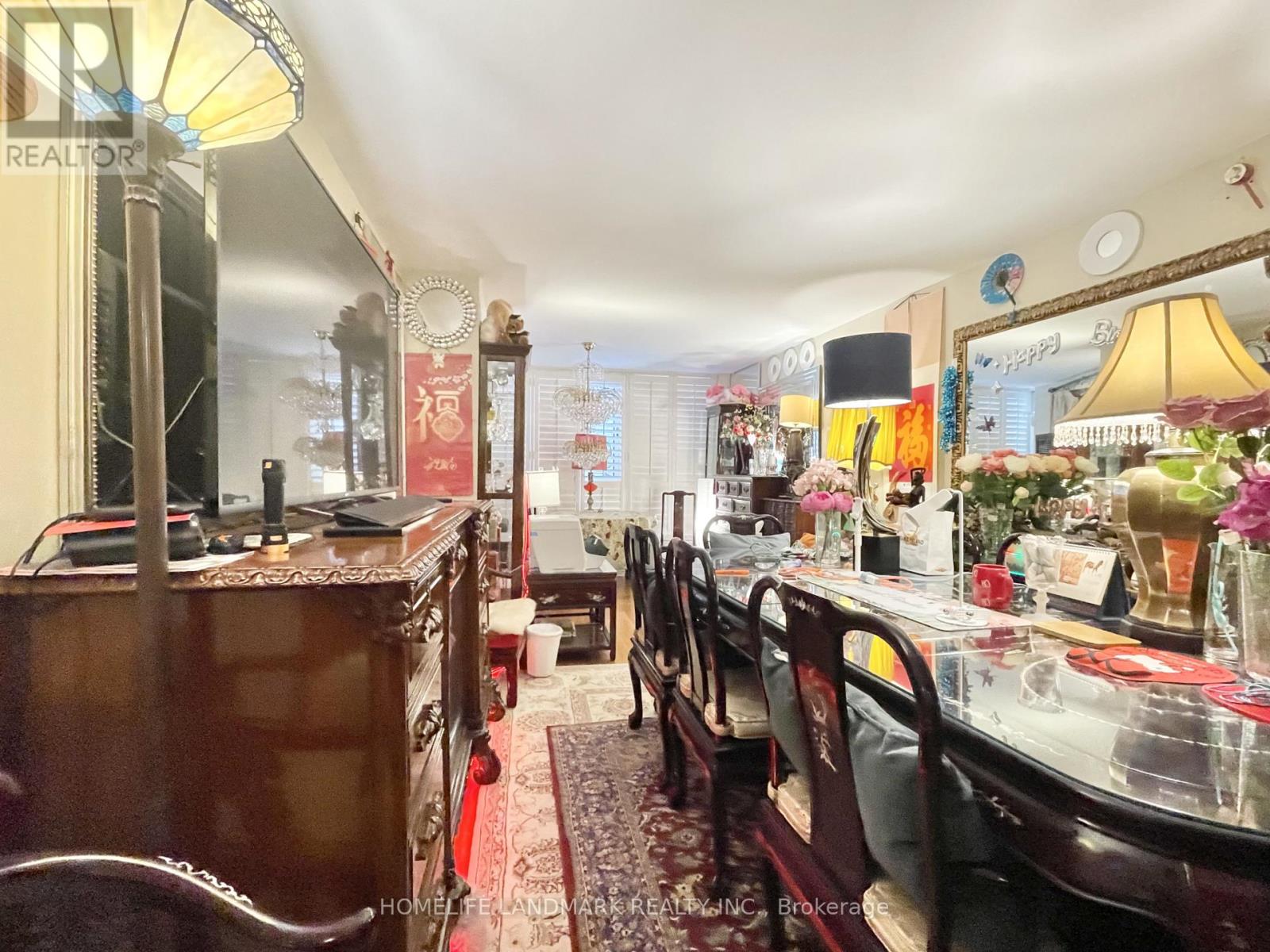 A dining room with a table set for a meal.
