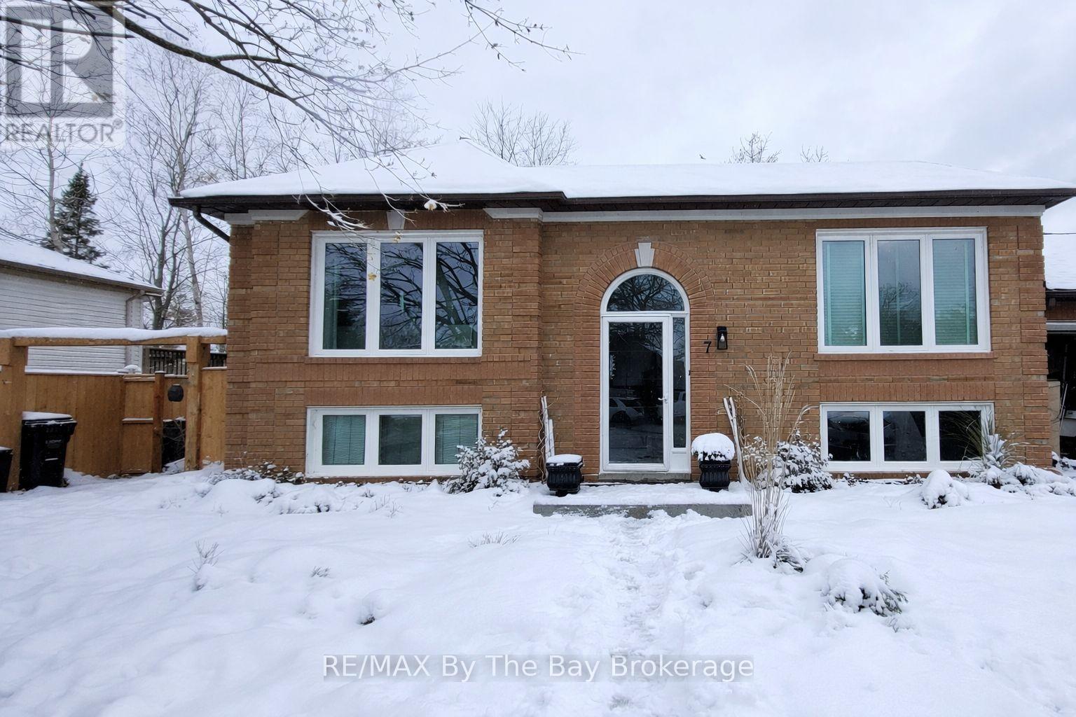 A house with a snow-covered front yard.