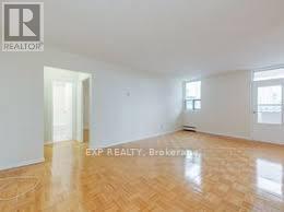 A room with wooden flooring and white walls.