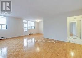 A room with wooden flooring and a window.