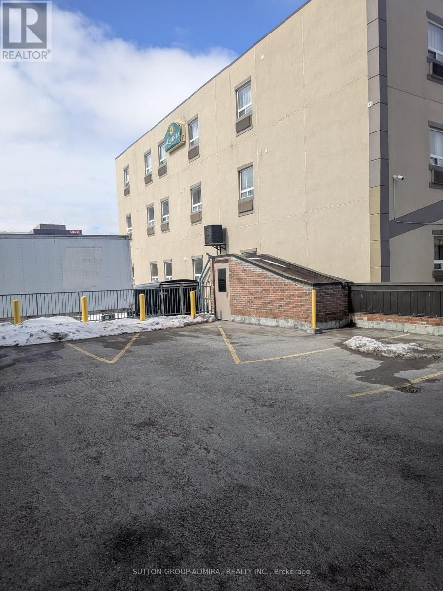 A building with a parking lot in front of it.