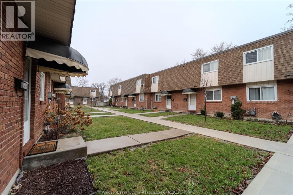 A row of houses with a Realtor sign in the foreground.
