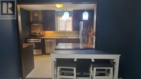 A kitchen with a stove top oven and a sink.