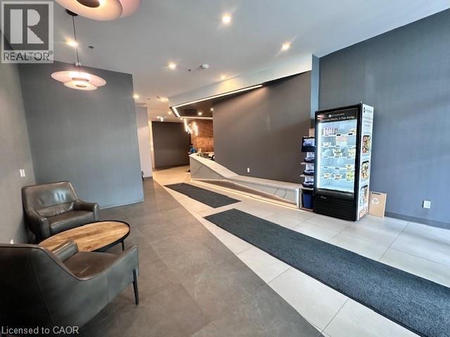 A realtor's office with a black and white rug and a black leather chair.