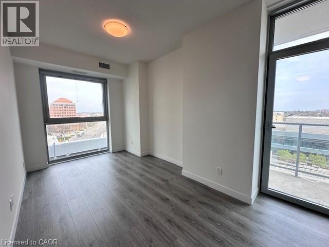 A spacious room with a large window overlooking a cityscape.
