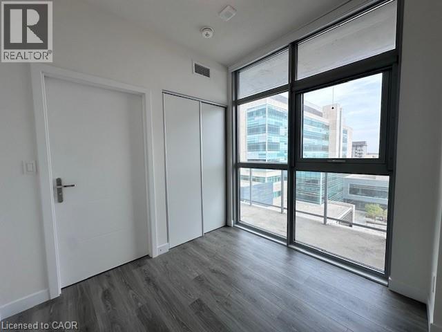 A room with a sliding glass door leading to a balcony.