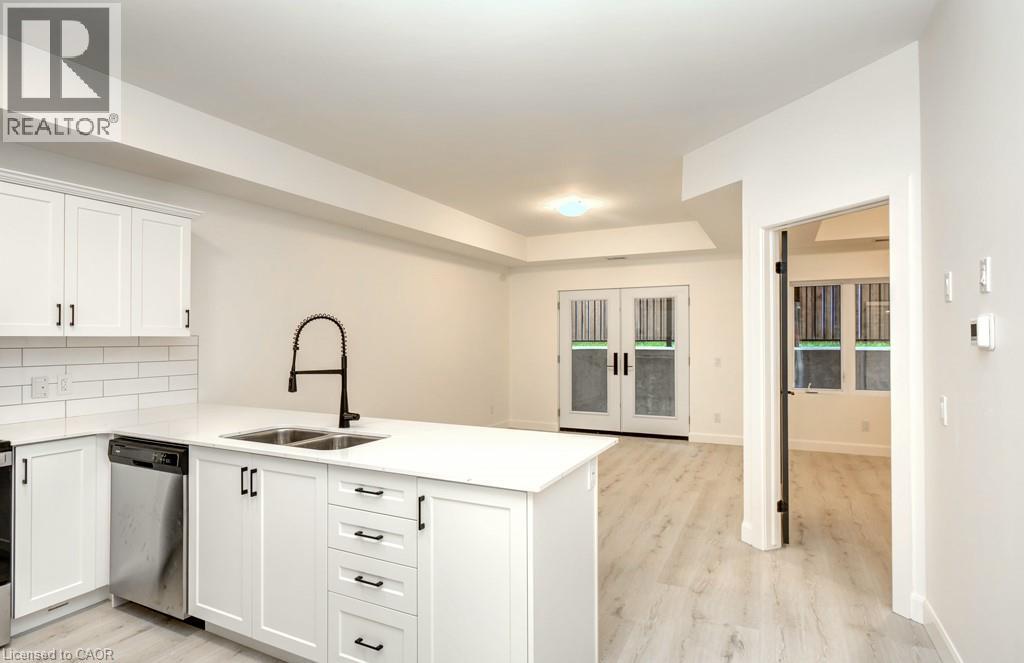 A white kitchen with a sink and a dishwasher.