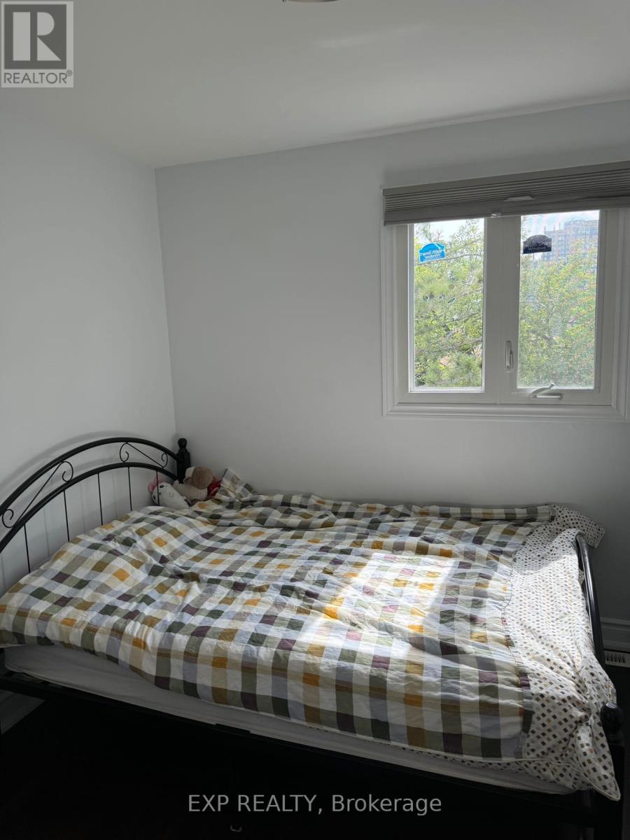 A bedroom with a bed and a window.