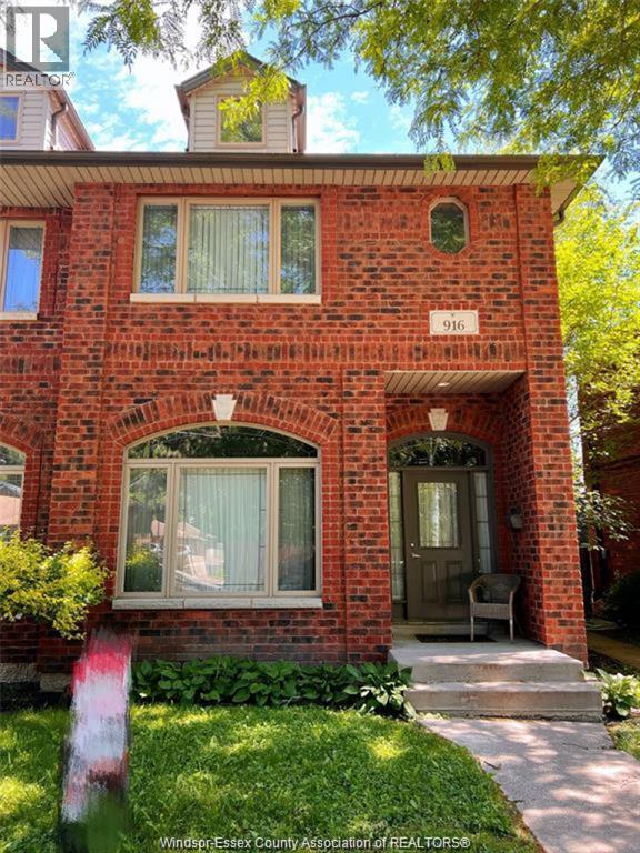 A red brick house with a number 916 on it.