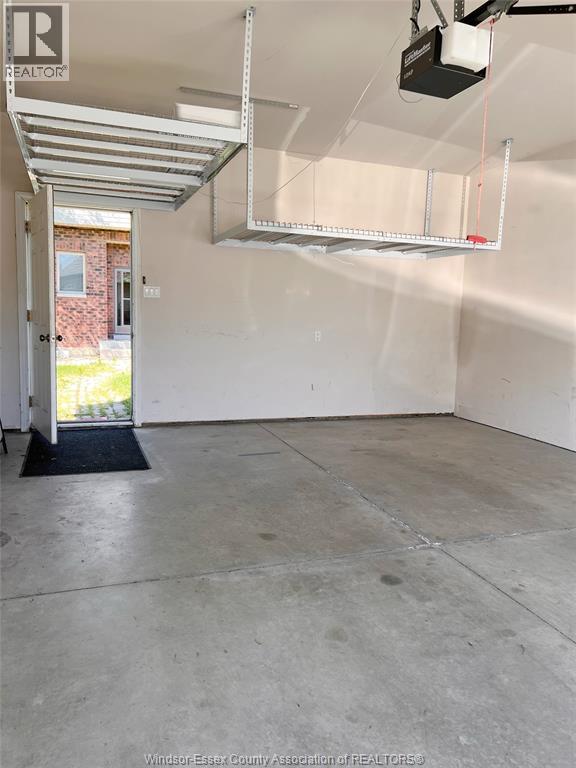 A room with a doorway leading to a brick building.