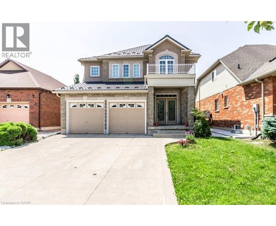 A two-story house with a garage is for sale.