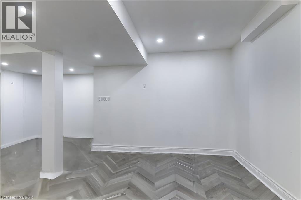 A room with a grey chevron patterned floor and white walls.