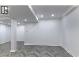 A room with a grey chevron patterned floor and white walls.