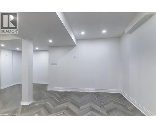 A room with a grey chevron patterned floor and white walls.