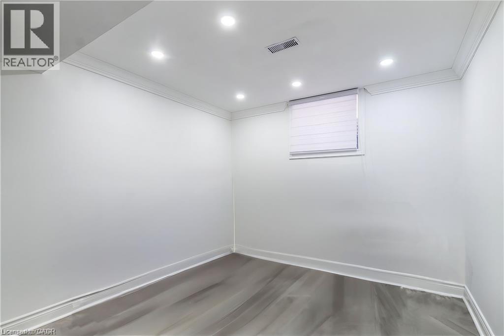 A room with a window and a wooden floor.