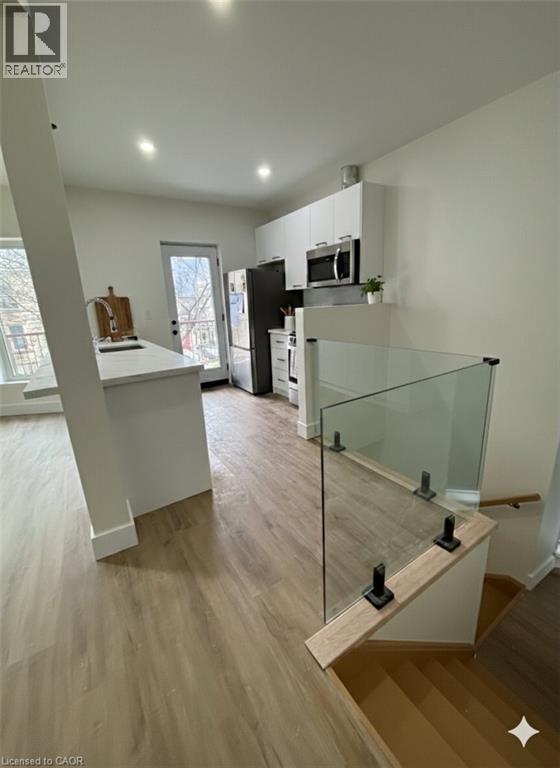 A modern kitchen with a glass railing.