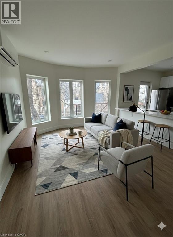 A living room with a grey sofa and a rug with a geometric pattern.