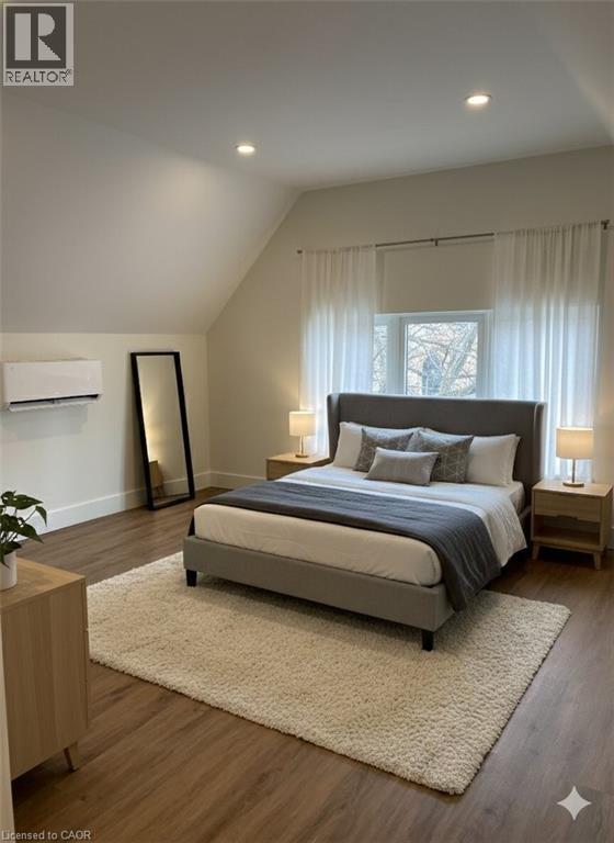 A bedroom with a large bed and a window with curtains.