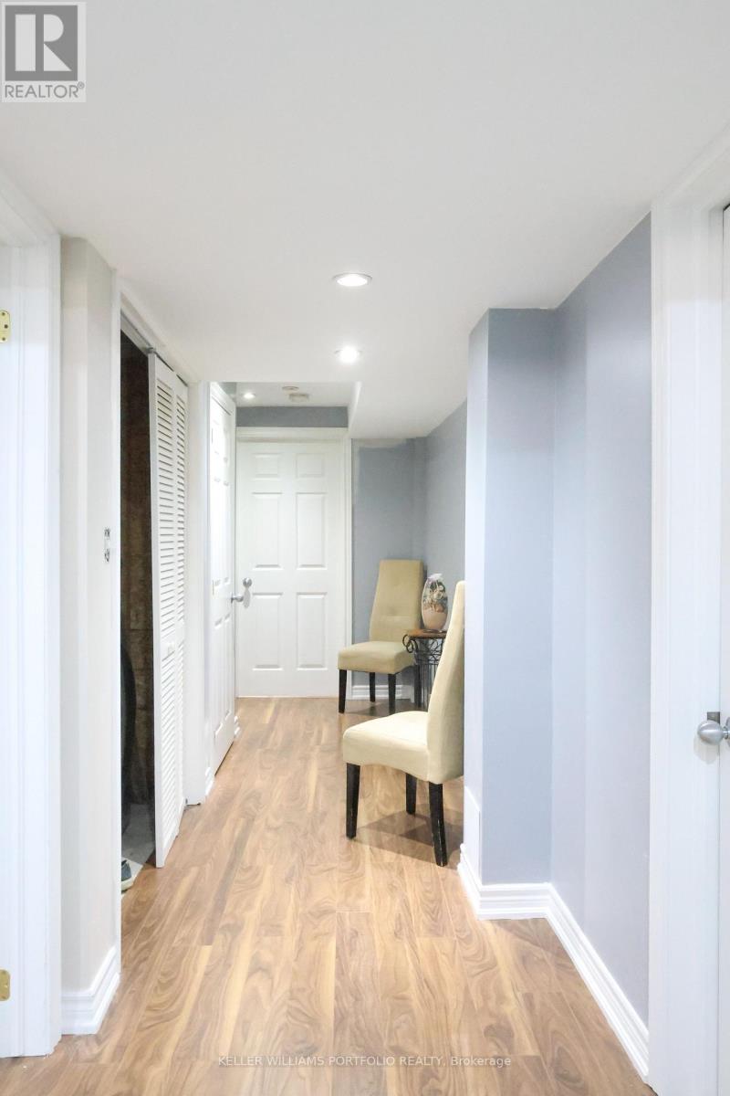 A hallway with a chair and a door.