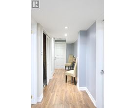 A hallway with a chair and a door.