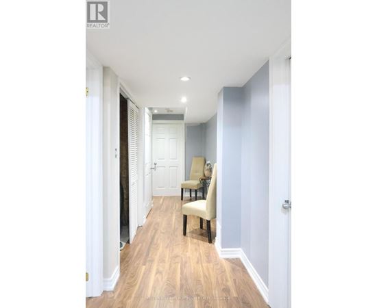 A hallway with a chair and a door.