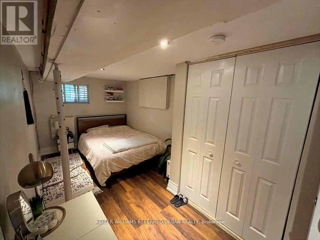 A bedroom with a bed, a chair, and a table.