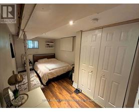 A bedroom with a bed, a chair, and a table.