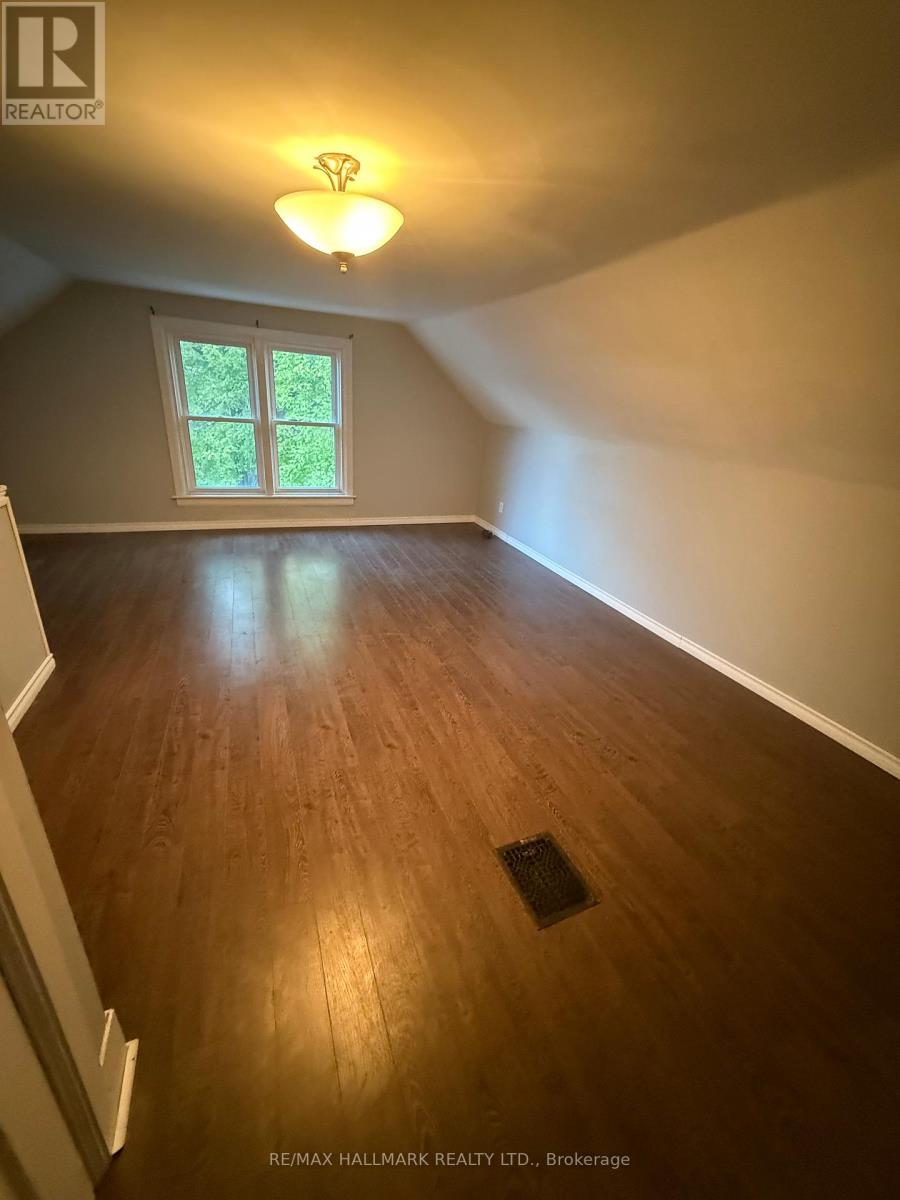 A room with wooden flooring and a window.